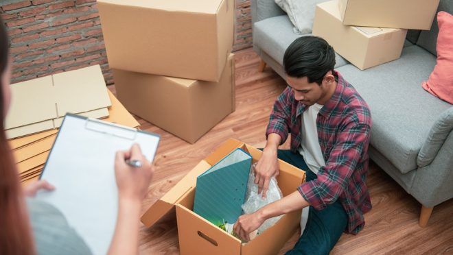 Young,Asian,Couple,Packing,Their,Belonging,Into,Cardboard,Box,Before