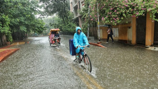 All smiles amid rainfall in Dhanmondi, Dhaka on 26 June 2024. Photo: Rajib Dhar