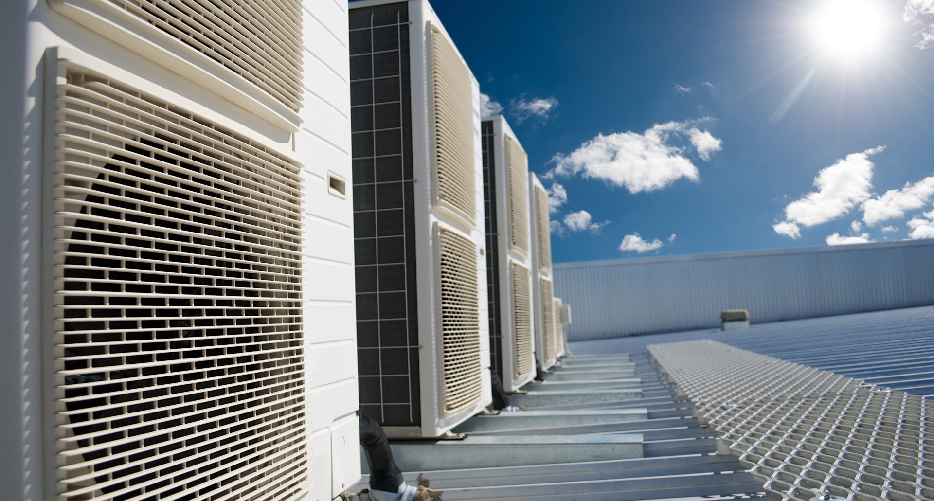 Air conditioner units with sun and blue sky