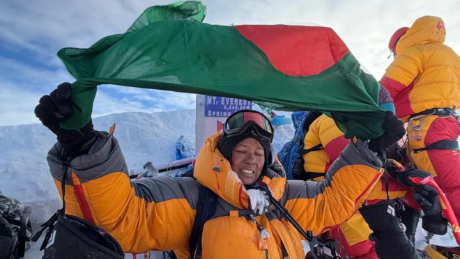 Nurunnahar Nimni celebrates atop Mount Everest with the Bangladesh flag after summiting the world’s highest peak. Photo: Courtesy
