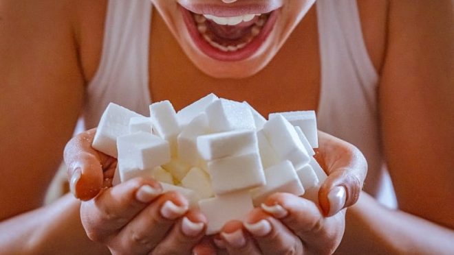 woman-handful-sugar-resized